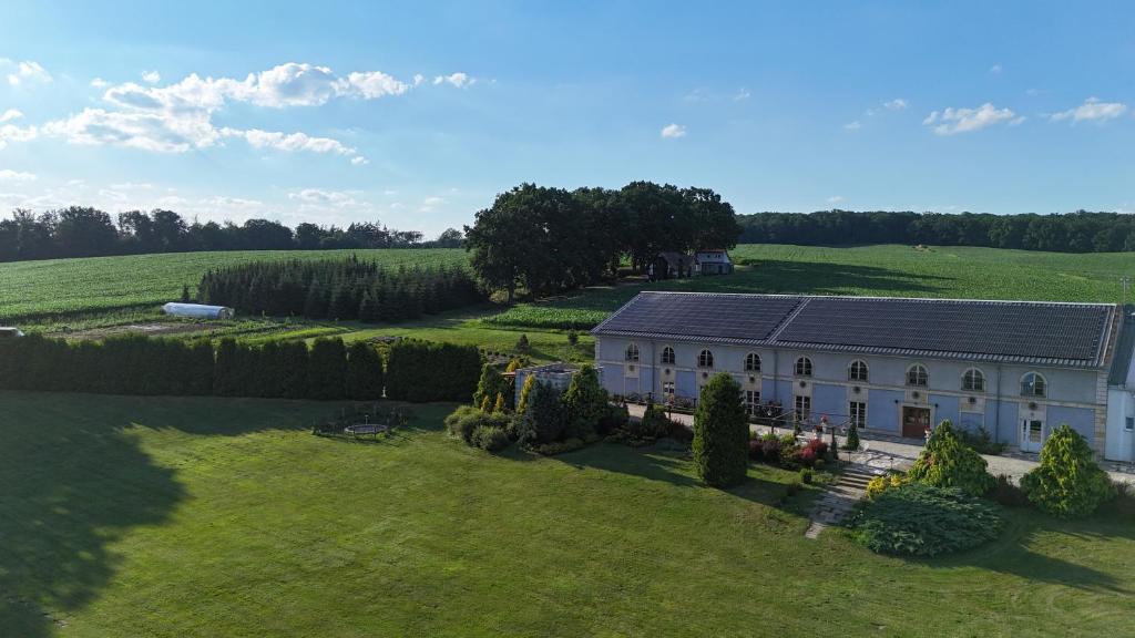 an aerial view of a large white house in a field at Stary Folwark Machnice in Machnice