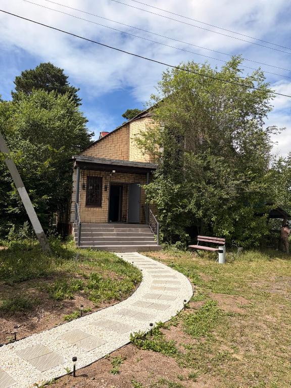 a house with a walkway in front of it at Burabay Lake Walk House in Borovoye