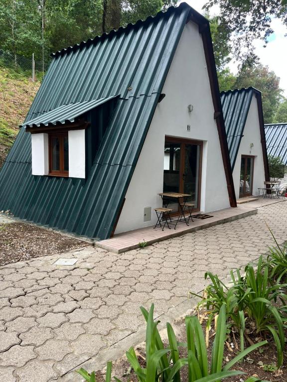 a small white house with a black roof at Bungalow Refúgio do Pezo T0 in Melgaço