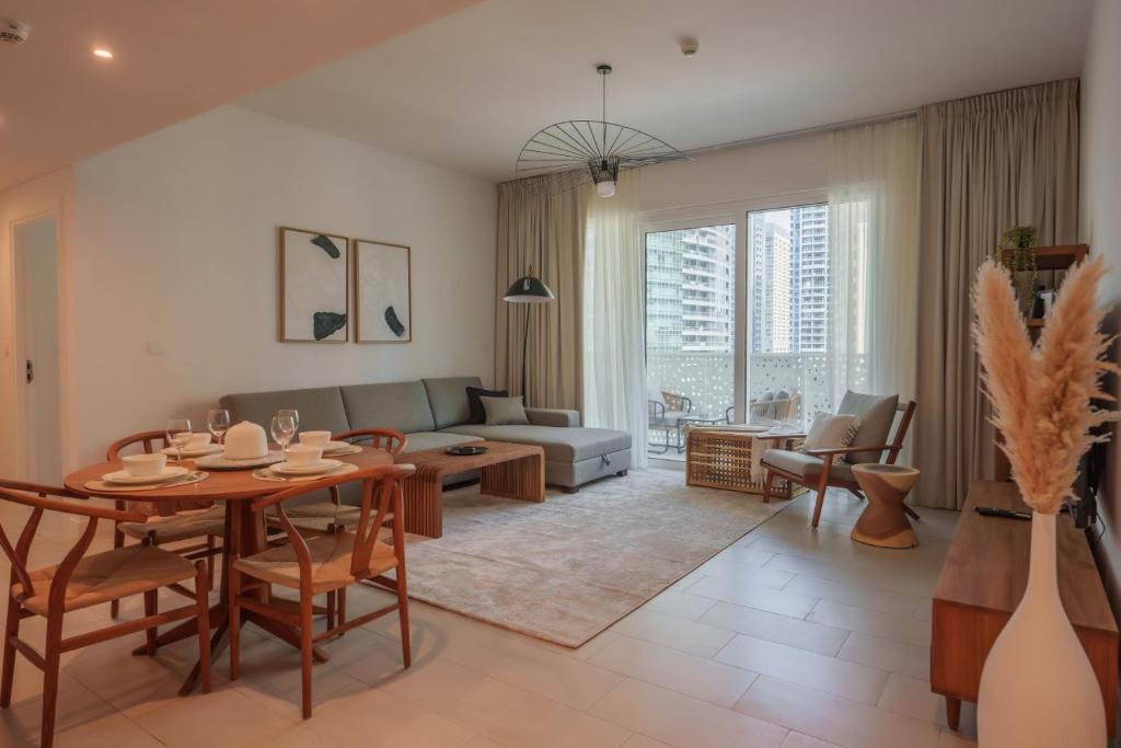 a living room with a table and a couch at La Vie, JBR in Dubai