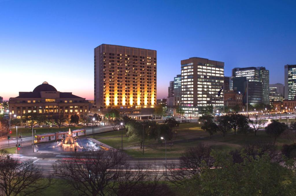 a city skyline at night with tall buildings at Amora Hotel Adelaide in Adelaide