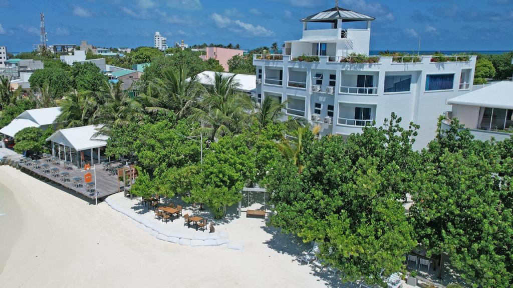 an aerial view of a resort with trees and a building at Rashu Hiyaa Hotel in Dhiffushi