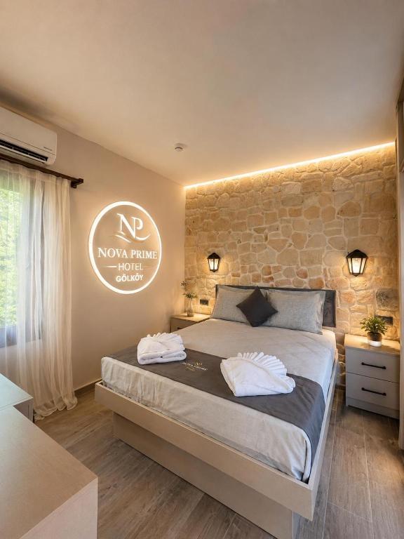 a bedroom with a bed with two towels on it at Nova Prime in Bodrum City
