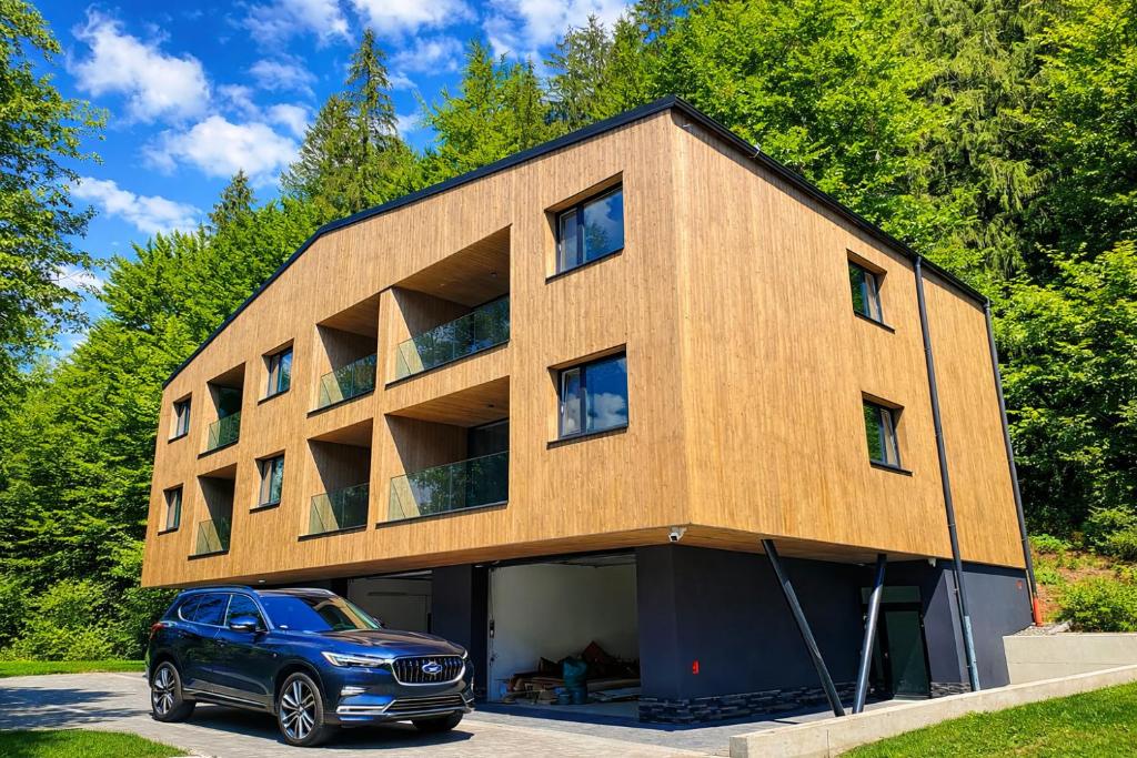 a car parked in front of a building at Apartmán Alica Tále in Bystrá