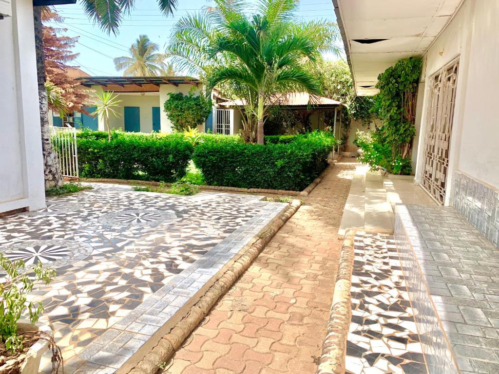 a courtyard of a house with palm trees at Belle view Villa in Serekunda
