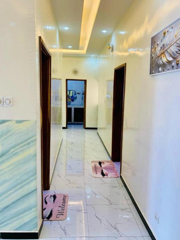 a hallway with two mats on the floor of a building at Kër-Mame Tawfekh in Thiès
