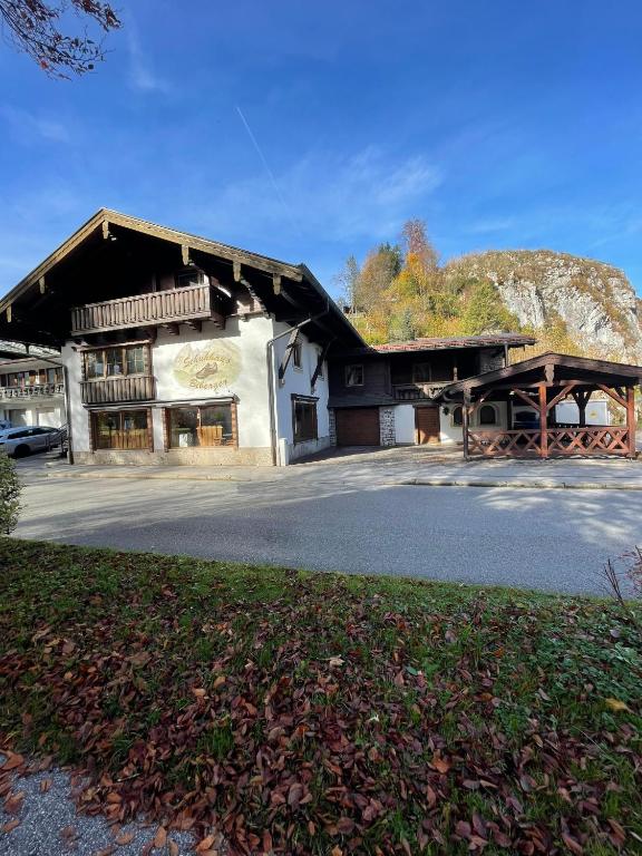 a large building with a mountain in the background at Schuhhaus Biberger - Fewo Lukas in Schönau am Königssee