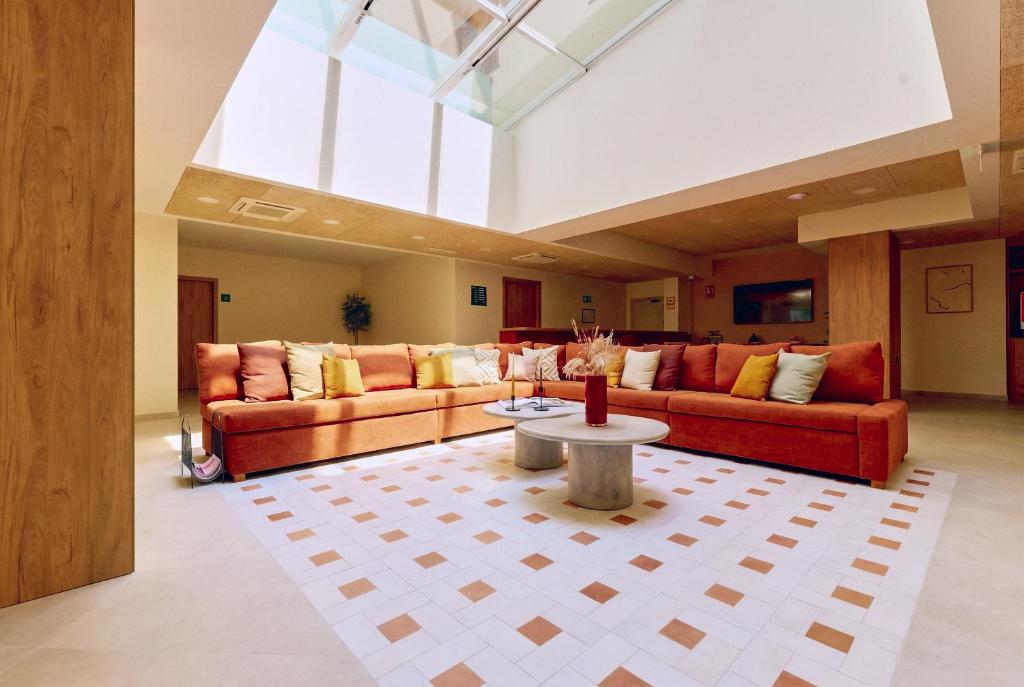 a living room with two couches and a table at Flipco Retiro in Madrid