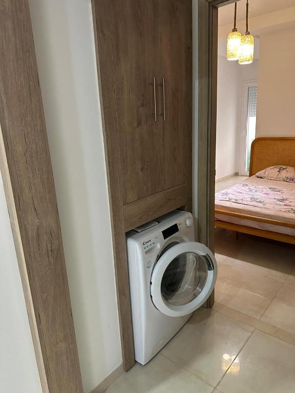 a bathroom with a washing machine in a room at Zaineb in Hammamet Sud