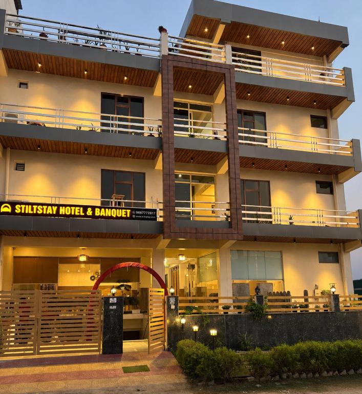 a building with a sign that reads slyley hotel and banquet at Hotel Stiltstay in Greater Noida