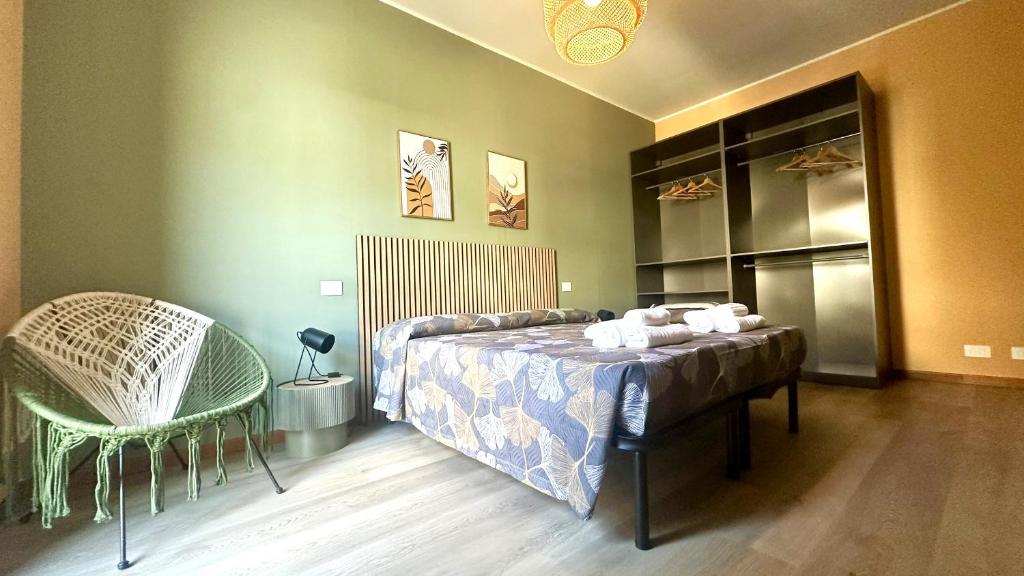 a bedroom with a bed and a chair in it at Nextop Homes in Tortona
