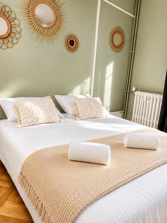 a large white bed with two pillows on it at l'Ecrin Bellevue in Aix-les-Bains