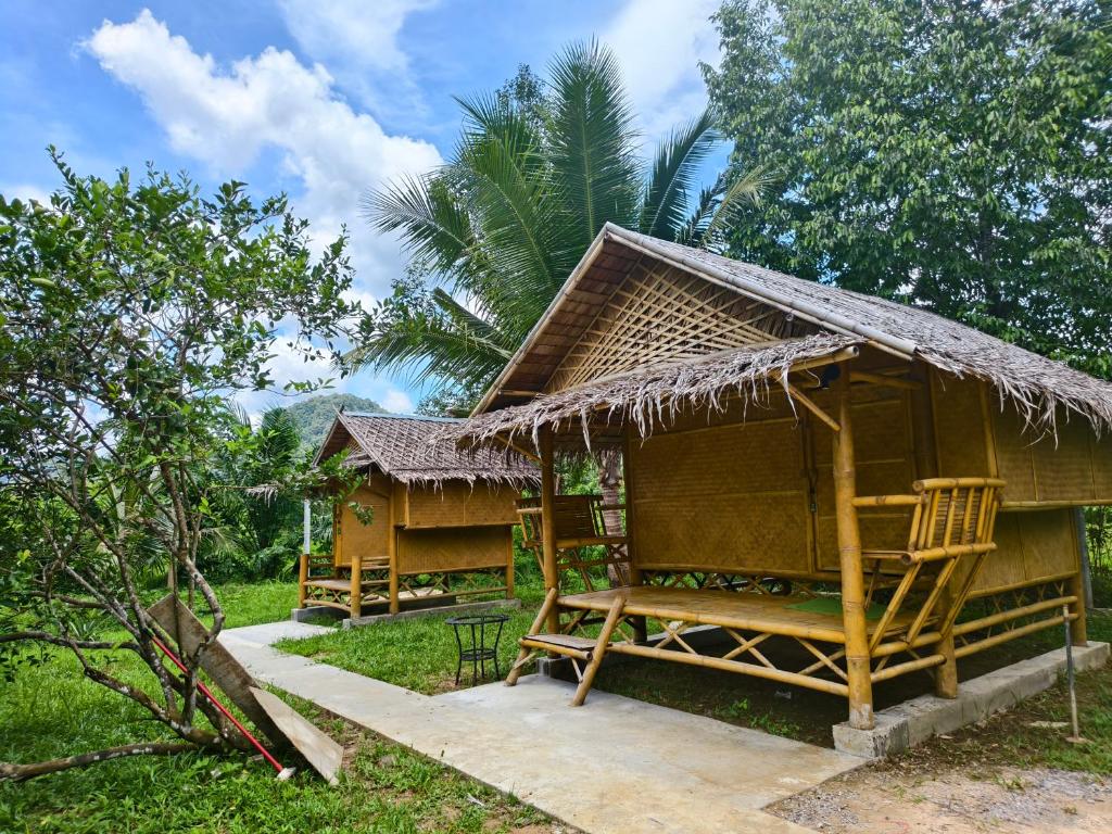 a small hut with a bench in front of it at Tarzan Bamboo hut in Khao Sok National Park