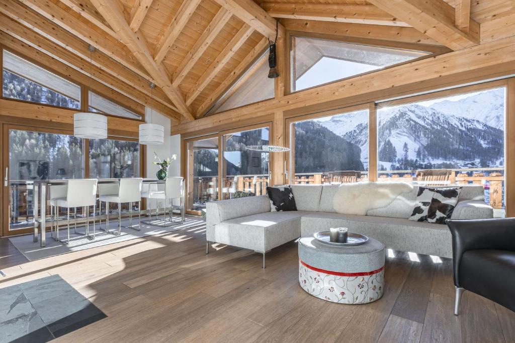a living room with a couch and a table at Chasa Teja by MEIN SAMNAUN - MOUNTAIN HOMES in Samnaun