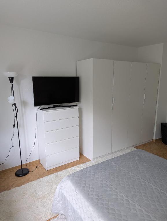 a bedroom with a bed and a flat screen tv at Holm in Melsungen