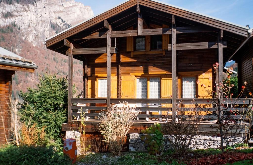 a wooden house with a mountain in the background at Chalet cosy à Sixt-Fer-à-Cheval avec vue sur la montagne in Sixt