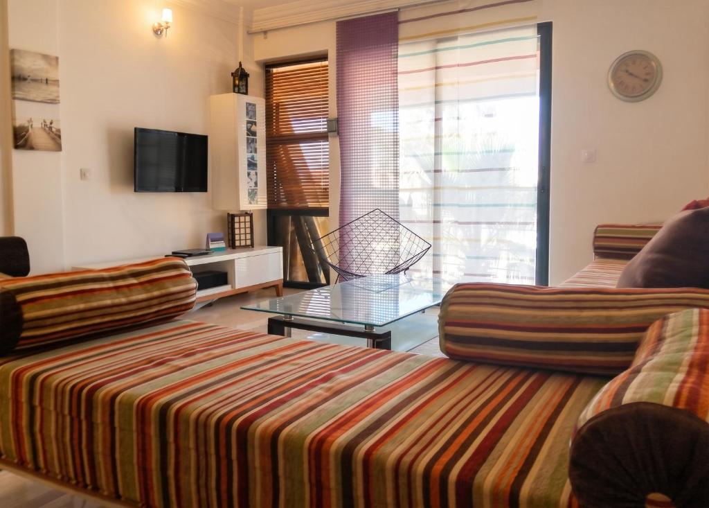a living room with a couch and a table at Charming Apartment in Imi Ouaddar in Agadir nʼ Aït Sa