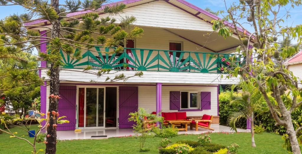 a house with purple and green trim at Charming Villa in Foulpointe with Sea View in Foulpointe