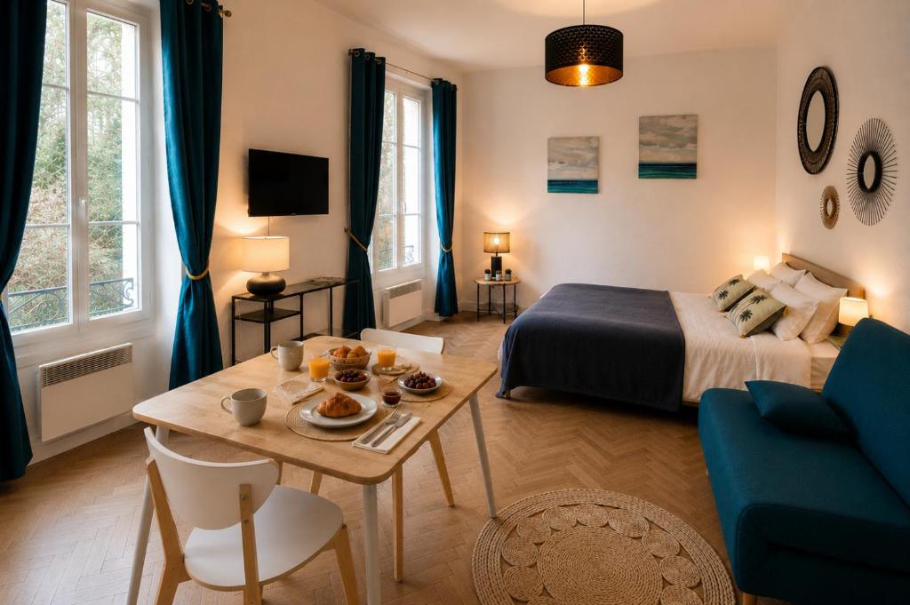 a bedroom with a bed and a table with food on it at le Riviera in Aix-les-Bains