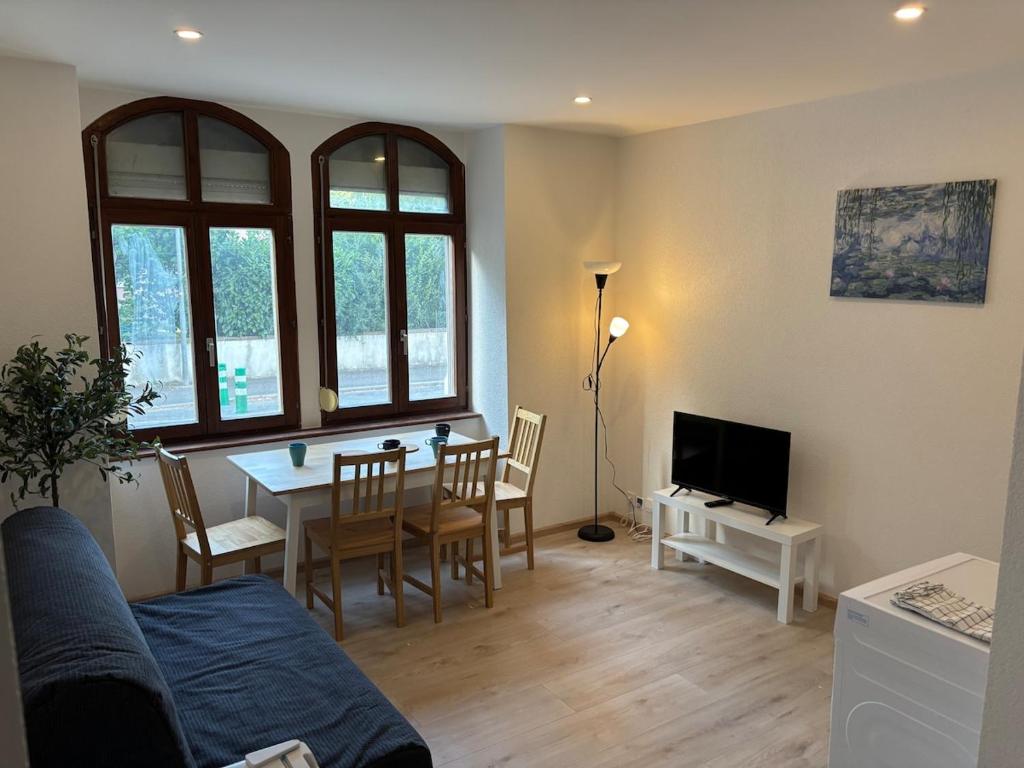 a living room with a table and a dining room at City Saint-Louis in Saint-Louis