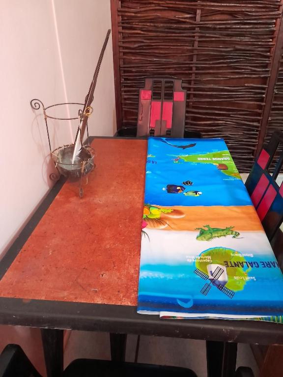 a table with a book on top of it at Studio confortable à Capesterre-de-Marie-Galante - 20 m² in Capesterre