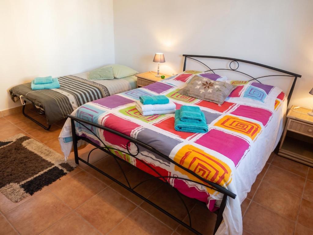a bedroom with a large bed with towels on it at Appartement accueillant à Penne-d'Agenais - 32 m² - Terrasse in Penne-dʼAgenais