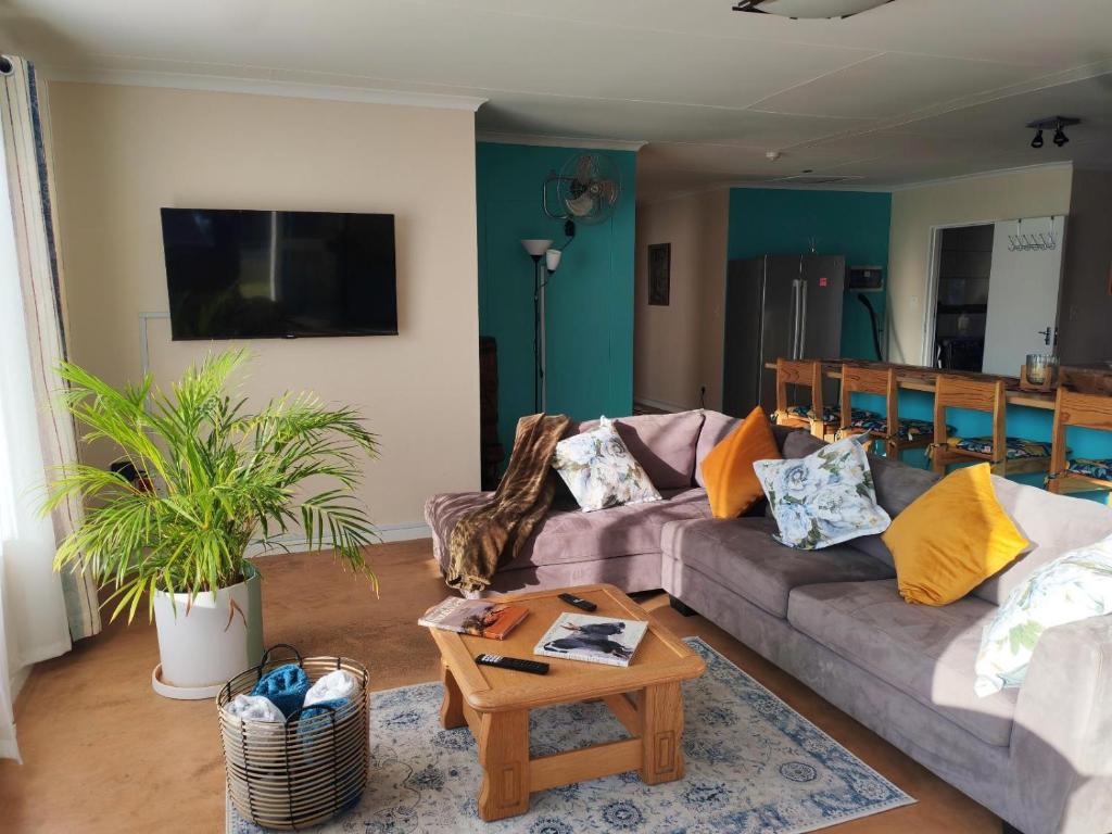 a living room with a couch and a coffee table at Prince and Pooch Self Catering in Windhoek
