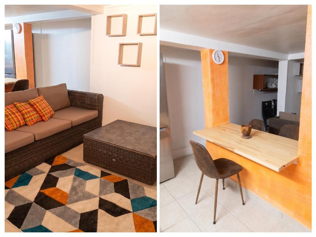 a living room with a couch and a table at Appartement charmant à Sainte-Rose avec terrasse et jardin in Sainte-Rose