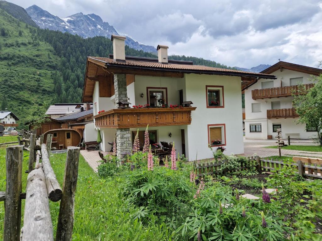 a house in the mountains with a wooden fence at Alpinchalet Ortler in Solda