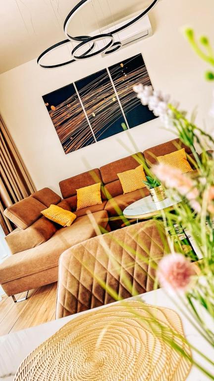 a living room with a couch and a table at Alexandra Nesvady in Nesvady