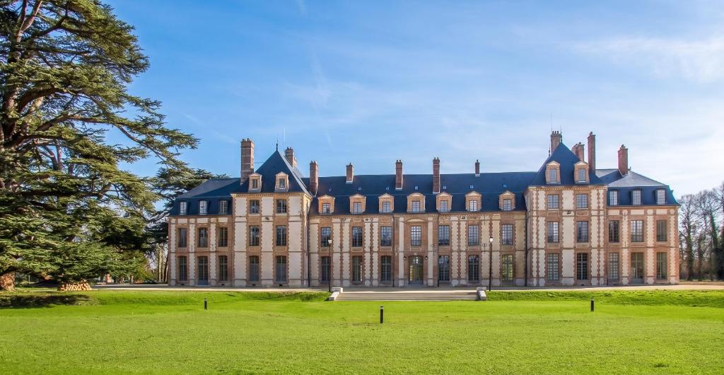 a large castle with a grass field in front of it at Charmant studio à Abondant avec terrasse ensoleillée - 30 m² in Abondant