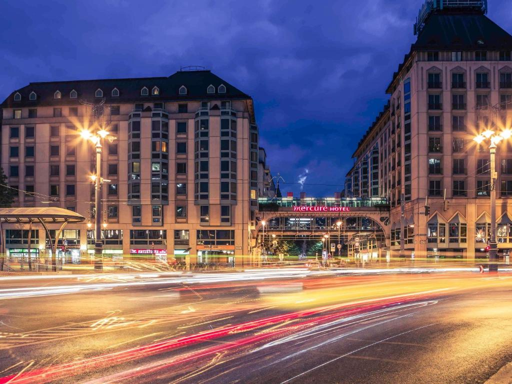 a city street at night with buildings and street lights at Mercure Budapest Korona in Budapest