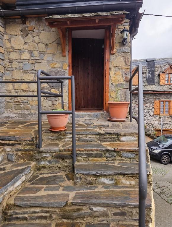 a stone house with steps leading to a door at Spacious House in Canejan with Mountain View in Caneján