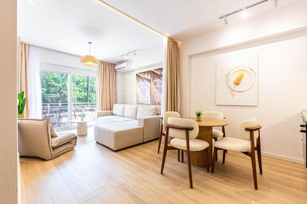 a living room with a table and a couch at Dhermi's Icon Big 1BR Apt 9 in Dhërmi