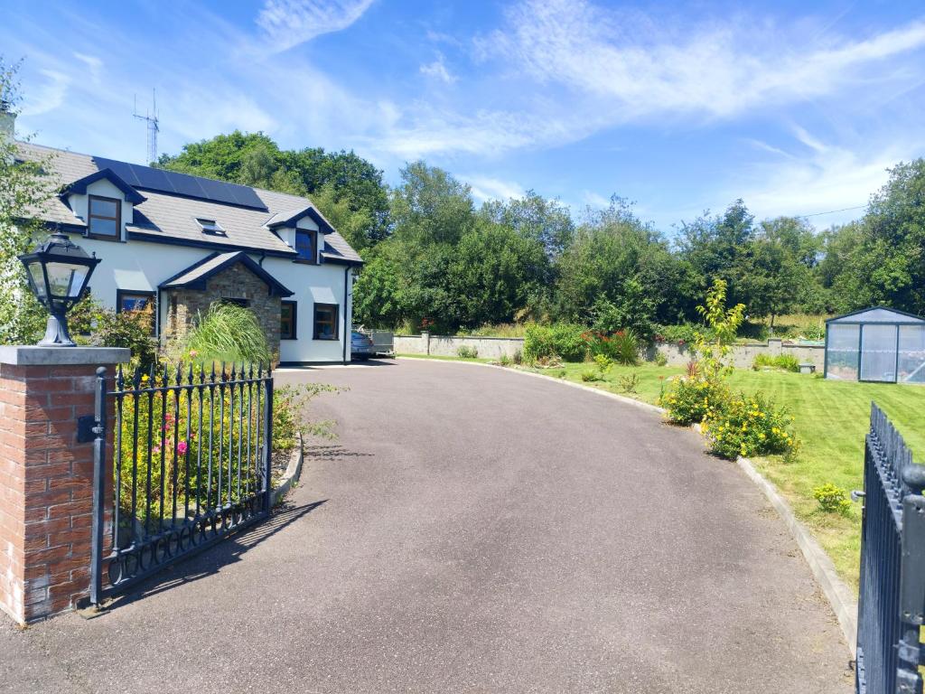 a house with a gate and a driveway at Radharc Sléibhe in Kilgarvan