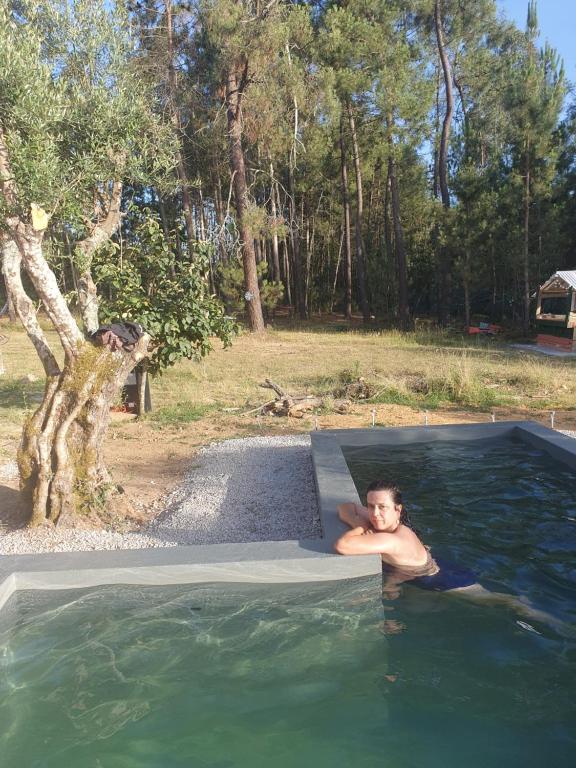 a man laying in a pool of water at Quinta Chaouen in Mouronho