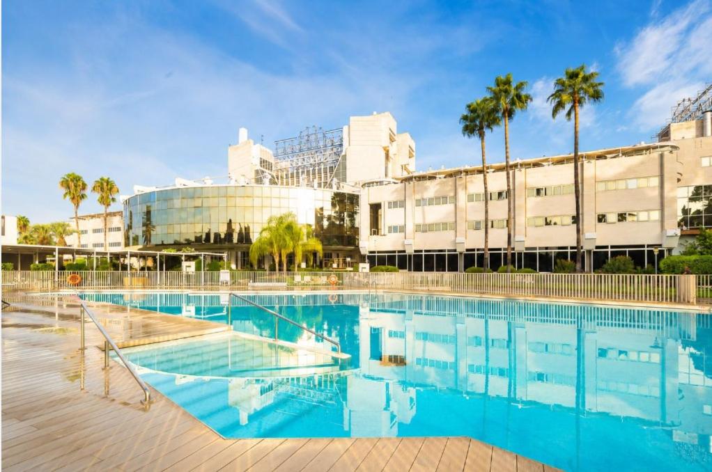a large swimming pool in front of a building at Eurostars Al-Ándalus Palace in Seville
