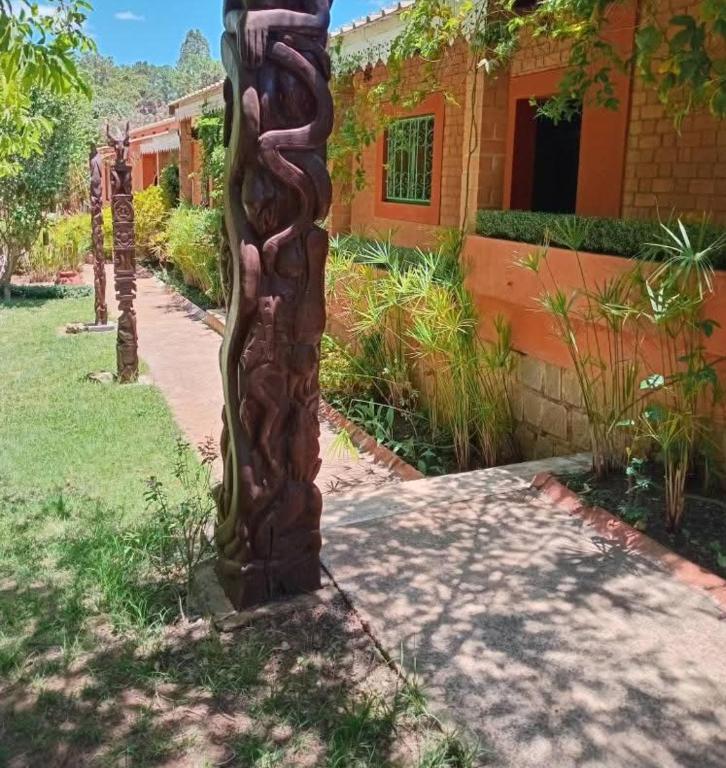 a totem pole in front of a building at Hôtel Mahavelo 2 étoiles in Antananarivo