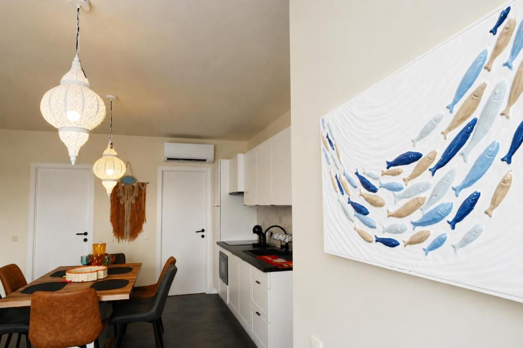 a kitchen and dining room with a large painting on the wall at BEACH house in Westende-Bad