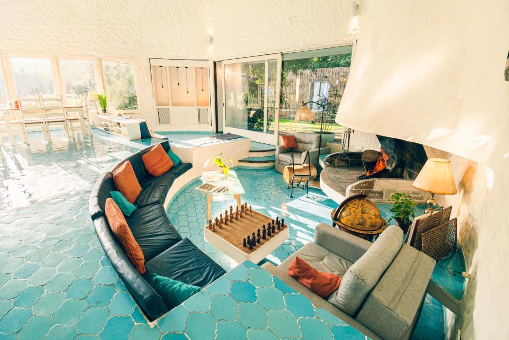 a living room filled with furniture and a fireplace at Posada CASA in Punta del Este