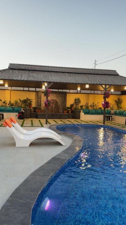 a swimming pool with a slide in front of a building at Villa Al Wesam in Amman