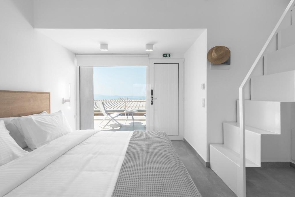 a bedroom with a bed and a view of the ocean at Twiins Studios by halu! - Next to Kallithea Beach in Kallithea Halkidikis