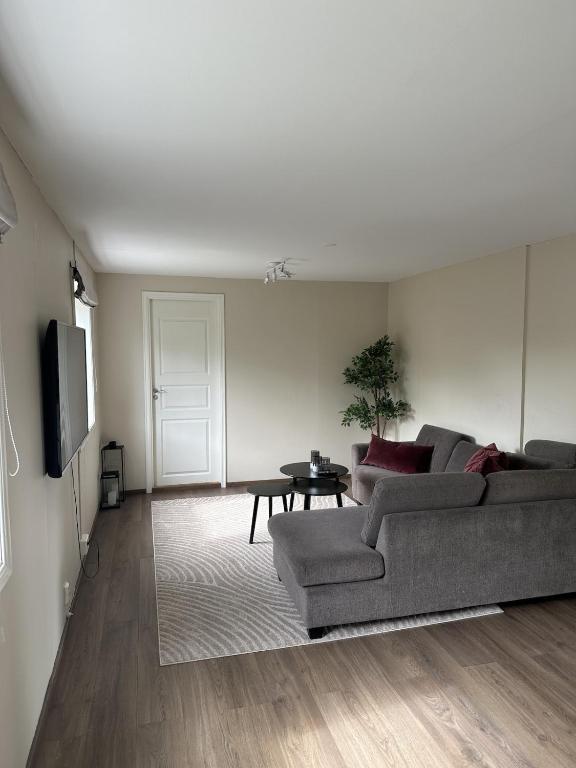 a living room with a couch and a table at Bright apartment in Haslum in Haslum 