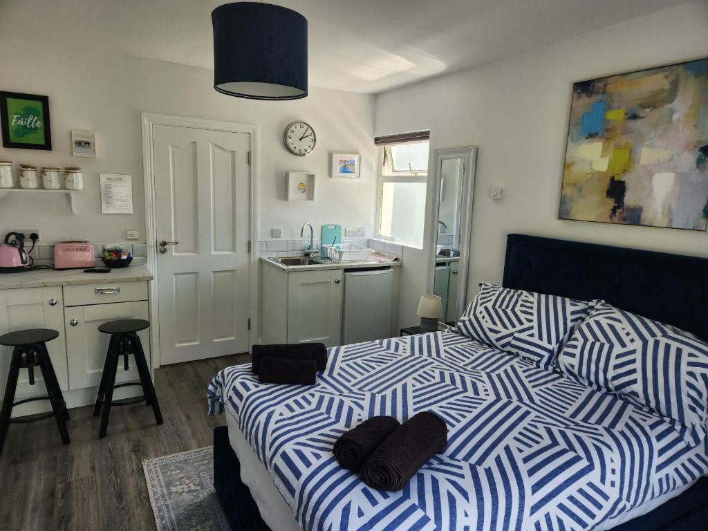 a bedroom with a bed with a blue and white comforter at The Lodge in Killarney