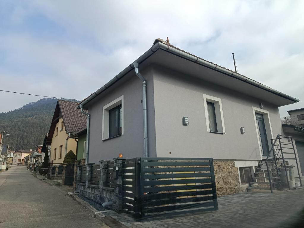 a house with a fence in front of it at Chalúpka Liptov in Lúčky