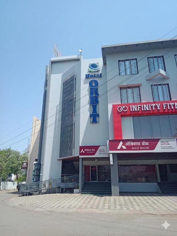 a building with a sign on the side of it at Hotel Orbit in Parbhani