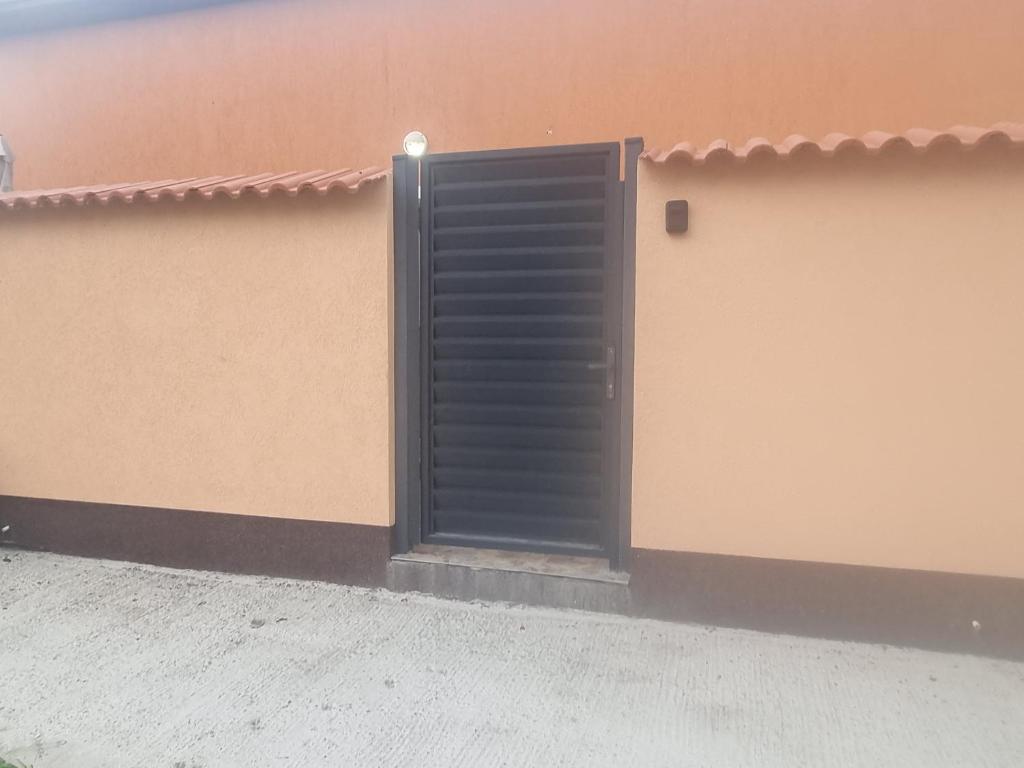 a black door on the side of a building at Casa Florentina in Făgăraş