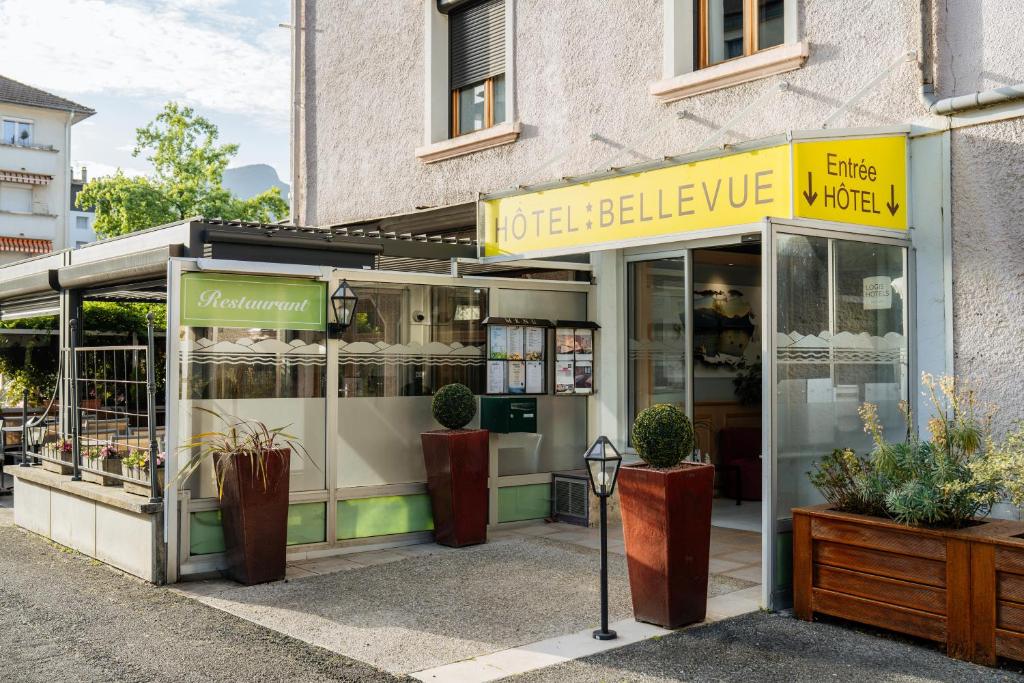 a store front of a building with plants in it at Logis Hôtel Restaurant Bellevue Annecy in Annecy