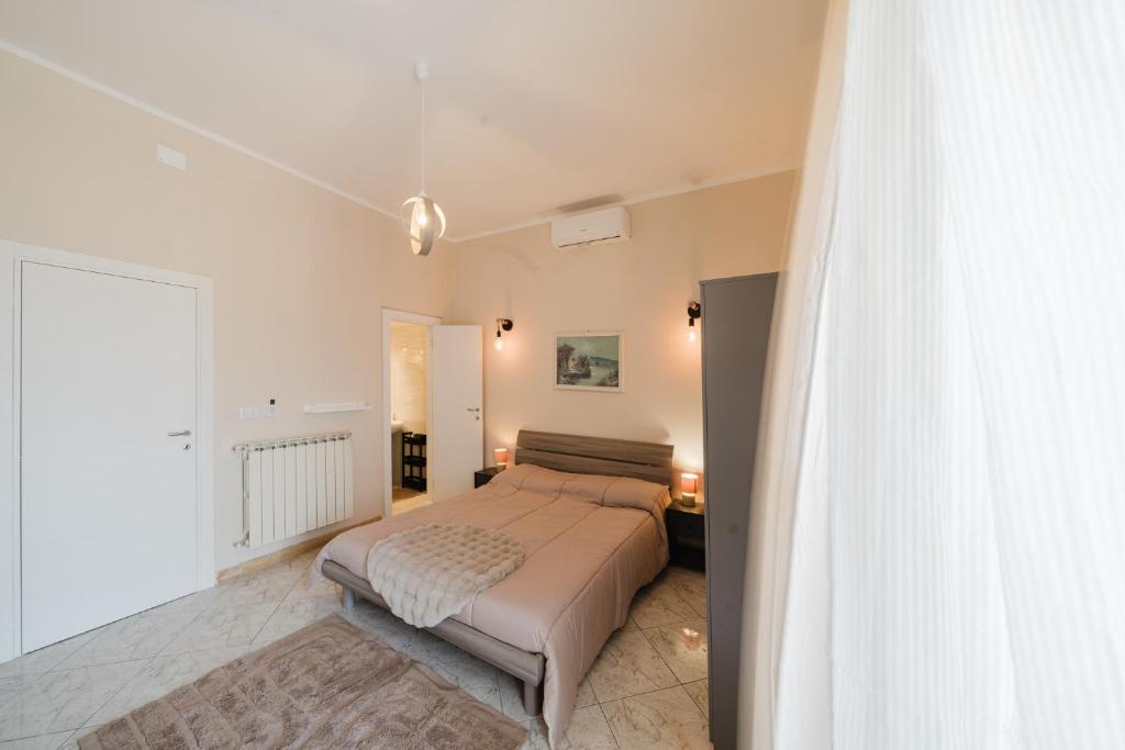 a bedroom with a bed and a large window at Guest House Michele in Orvieto Scalo