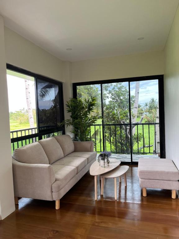 a living room with a couch and a table at Mystical Hidden Farmhouse in Camiguin